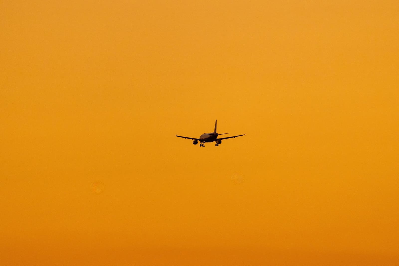 Jet climbing through an orange evening sky