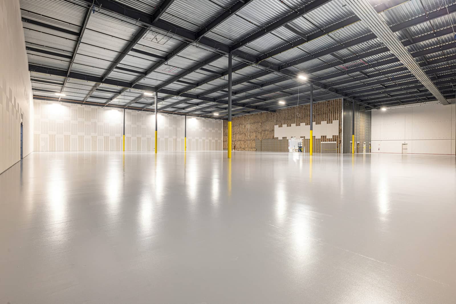 Clean, empty high-bay warehouse ready for storage