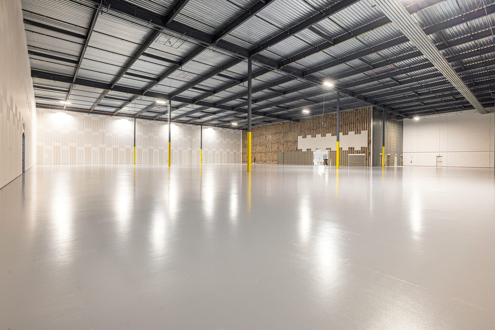 Clean, empty high-bay warehouse ready for storage